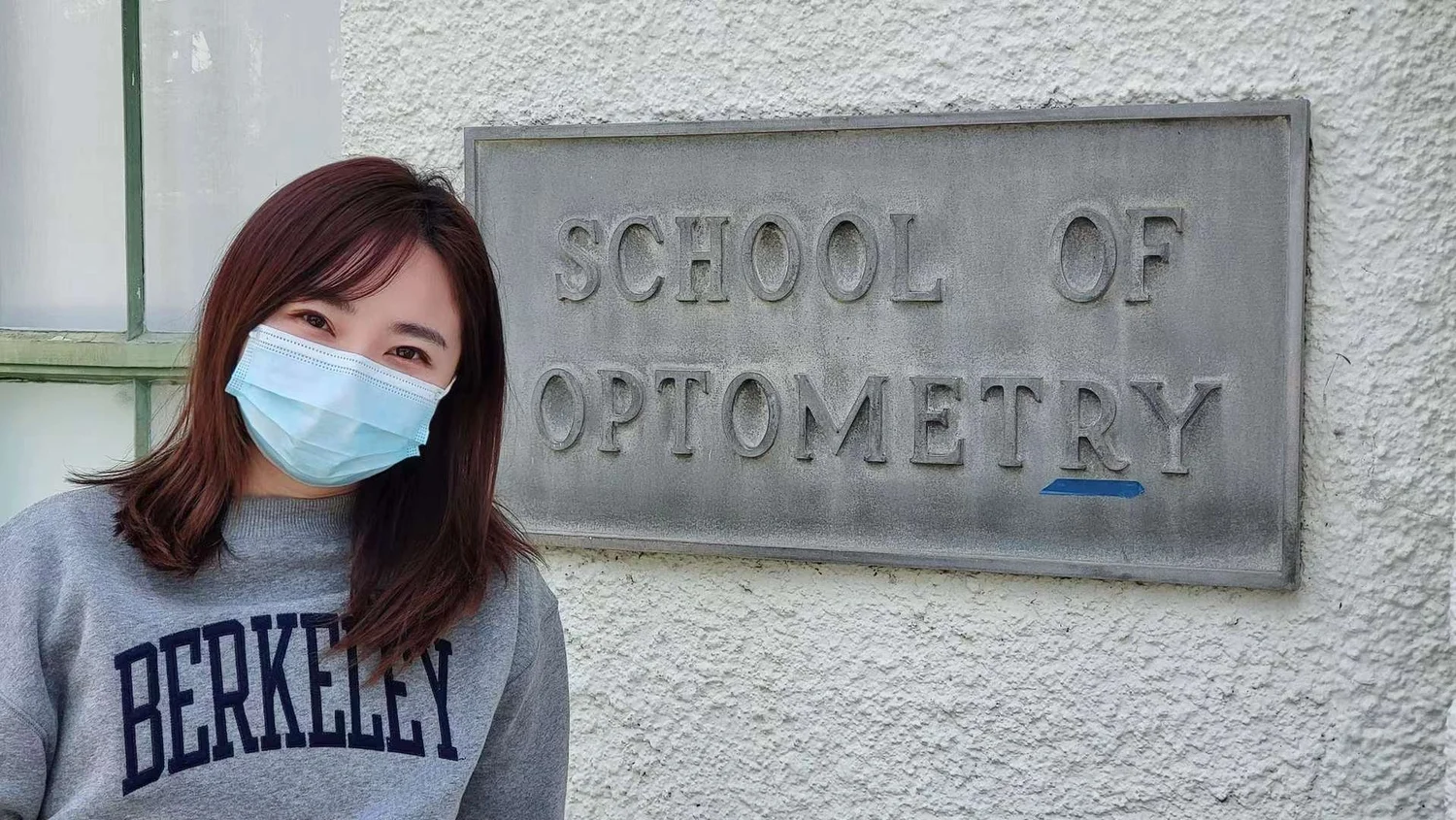 Olivia Cheng by the UC Berkeley School of Optometry sign